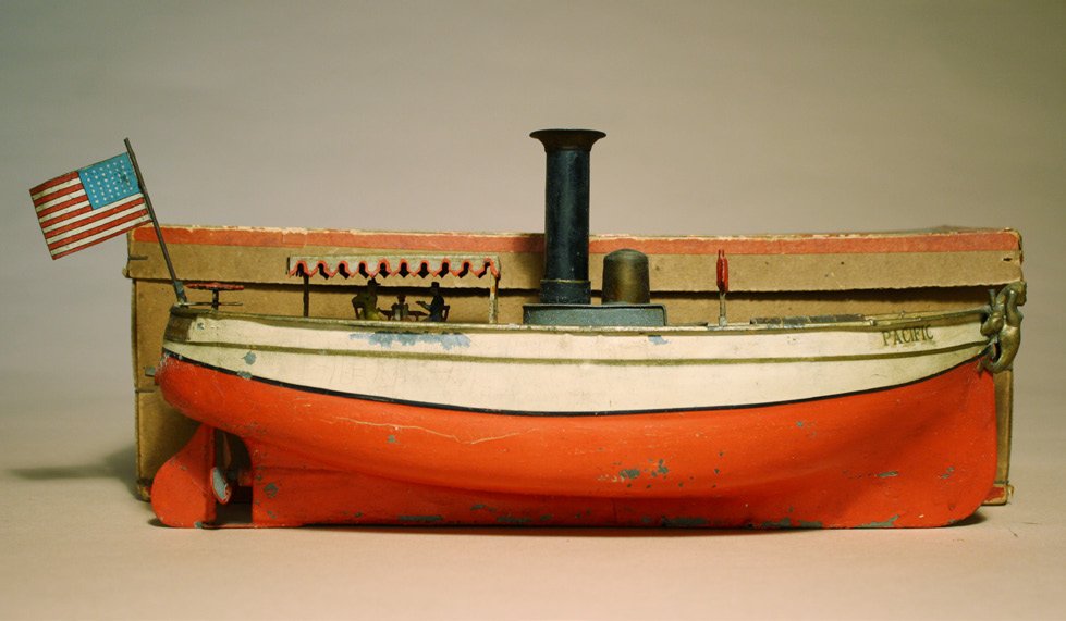PacificÓ Motor Launch: German Ð Circa 1920 This toy is 12 1/2Ó long and a wind up. It has great charm with a couple under the canopy. Presently not working. Material: Tin