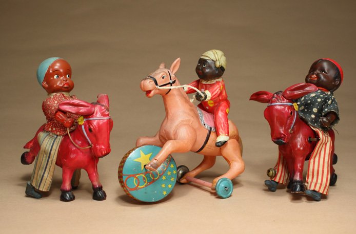 Lot: Three Equine Toys Japanese: Circa 1950s Two with black boys riding donkeys and one riding a horse. All work well. They are about 5 1/2Ó Ð 6 1/2Ó long. Material: Celluloid and Tin