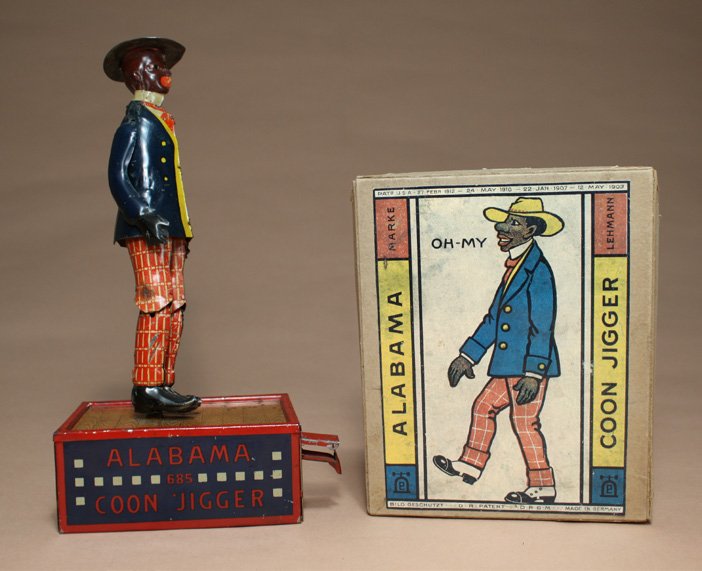 Alabama Coon Jigger with Box Top: E. P. Lehmann Germany Ð Circa 1920 This is a classic E. P. Lehmann toy that is colorful and charming. It works really well. Material: Tin with Cardboard Box Top