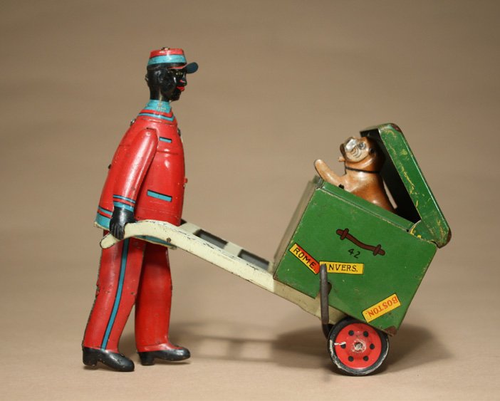 Porter with Luggage: Ferdinand Strauss Company New York, New York Ð Circa 1925 This is a great windup toy depicting a dog emerging from the trunk as the toy rolls along. Material: Tin