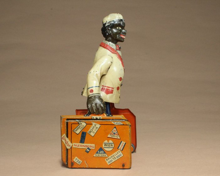 Porter with Bags J. Distler: Nuremberg, Germany Ð Circa 1920 The walking porter with luggage is a wonderful German litho toy. It work very well. Material: Tin