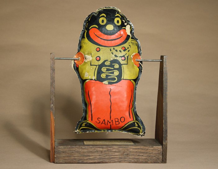 Sambo Knock Down: Crawford Mfg. Co. Richmond, Virginia Ð Circa 1935 This colorful knock down toy is 11 1/2Ó tall. Either bean bags or balls can be used. Material: Wood and Fabric
