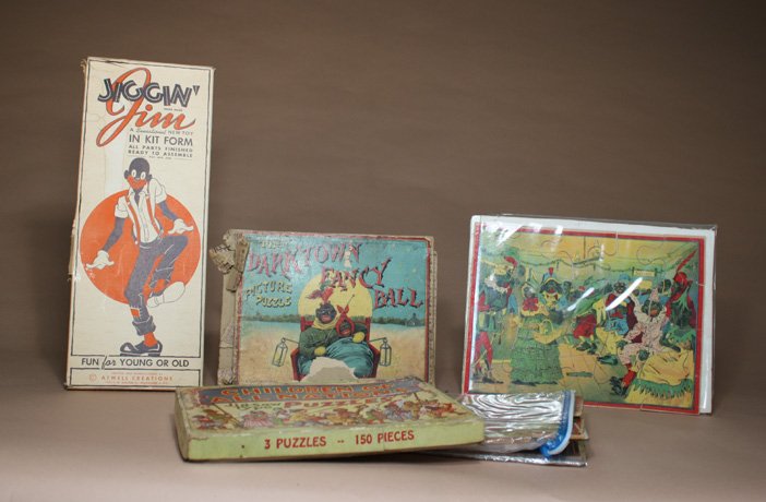 Lot: Four Jigsaw Puzzles and JigginÕ Jim: American Ð Circa 1920 Ð 1935 Darktown Fancy Ball jigsaw puzzles and two others. Material: Cardboard and Paper