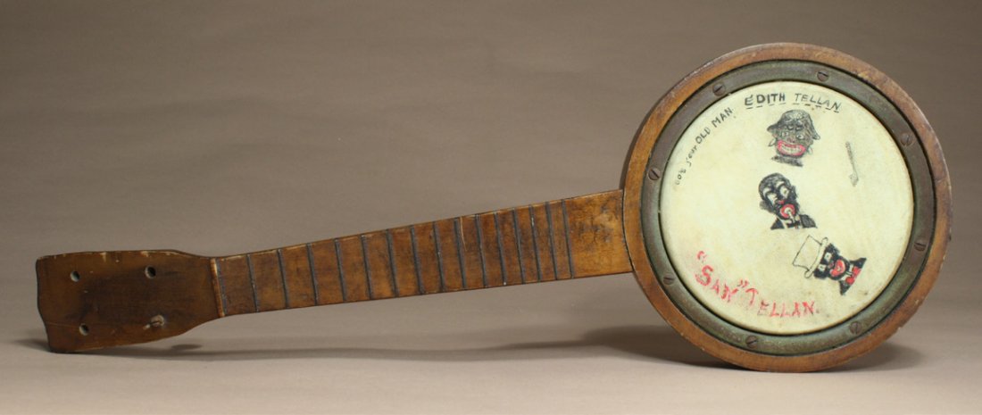 Folk Banjo, ÒSanÓ Tellan: American Ð Circa 1915 This is a small banjo that has hand painted minstrel images and marked ÒSanÓ Tellan. It is 21Ó long. Material Wood and Hide