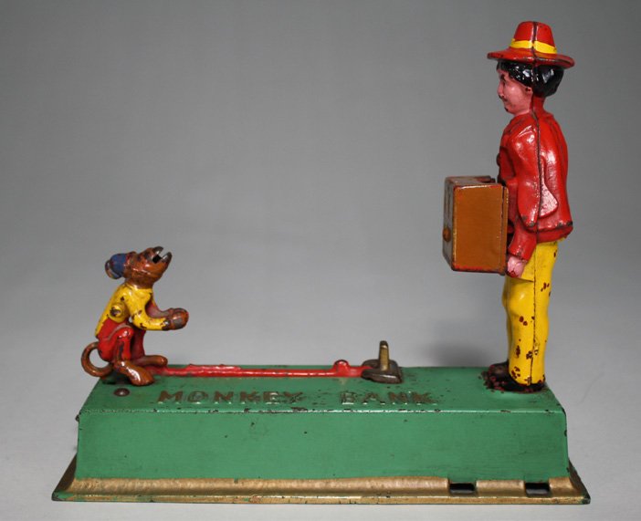 Monkey Bank: Made by Hubley Manufacturing Company Lancaster, Pennsylvania Ð Circa 1930 The monkey springs forward to deposit the coin into the organ grinderÕs hurdy-gurdy. Material: Cast Iron