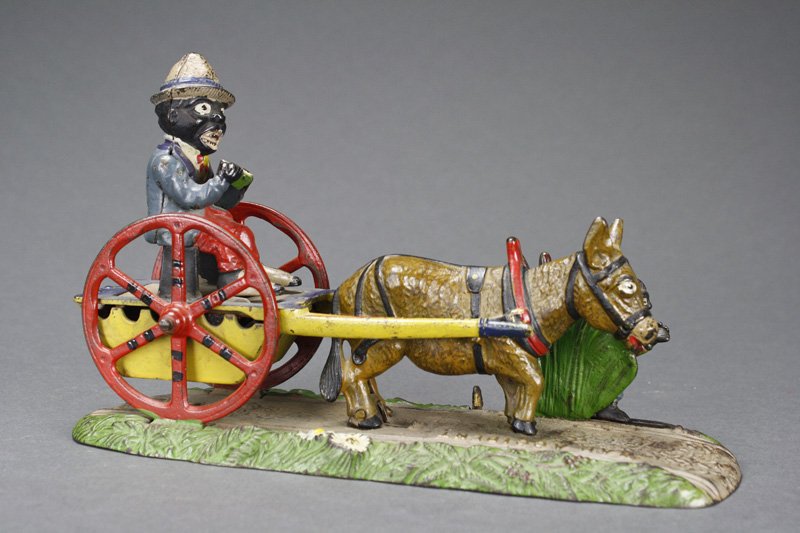 Bad Accident Mechanical Bank: Made by the J. & E. Stevens Company • Cromwell, Connecticut – Circa 1888 This is a racist depiction of a black driver eating watermelon as he takes his cart to market. The moral of this bank is, w
