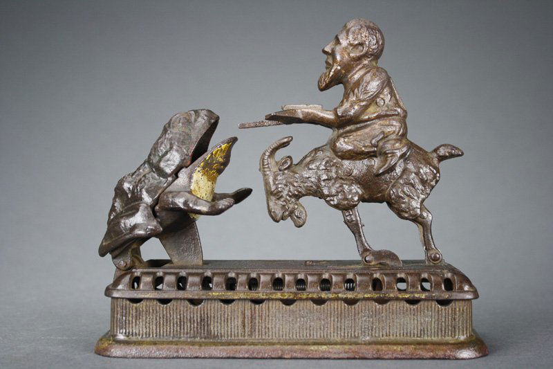 Initiating Bank - 2nd Degree Mechanical Bank: Made by Mechanical Novelty Works New Britain, Connecticut - Circa 1885 Also known as the “Goat, Frog and Old Man”. It functions by placing a coin in the man’s tray and then either pressing the b