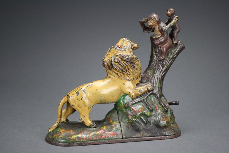 Lion and Two Monkeys, Single Peanut Mechanical Bank: Manufactured by the Kyser & Rex Company Philadelphia, Pennsylvania – Circa 1883 The shape of the knot in the tree is known as the “single peanut” by collectors. Therefore, it is approximately ?�