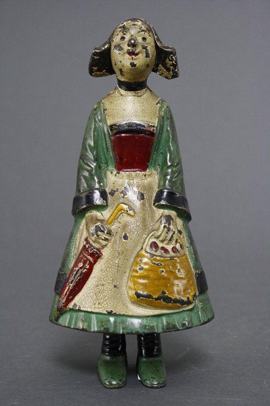 Comic Character Girl Still Bank: French - Circa 1900 This is an extremely scarce French made bank. Only a handful of these banks are known to exist. She is based upon a 19th century comic figure. Material: Cast Iron
