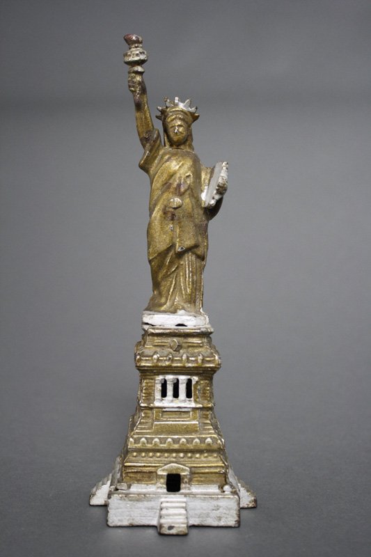 Statue of Liberty - Gold & Silver Architectural Bank: Kenton Hardware Kenton, Ohio - Circa 1910 This is a rare gold painted version of the bank with silver highlights. Kenton rarely painted banks in this manner, but see the Flat Iron at CIBB 185C. This i