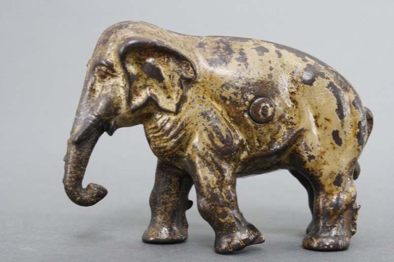 Elephant with Bent Knee Still Bank: Kenton Hardware Kenton, Ohio - Circa 1905 Material: Cast Iron