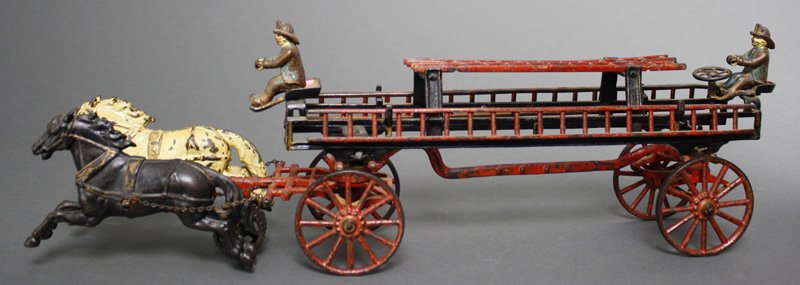 Hook & Ladder with Elevated Support Cast Iron: Carpenter Toys New York - Circa 1885 This configuration of Carpenter's hook and ladder is very scarce. It retains both original figures and is 25" long. Material: Cast Iron