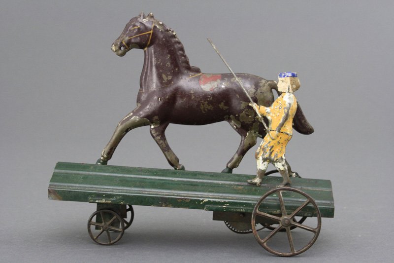 Horse Trainer Clockwork American Tin: George Brown Company Forestville, Connecticut - Circa 1880's Clockwork platform toys are exceedingly rare. 8 1/2" long. It works well. Material: Tin Provenance: Malcolm Diesenroth Collection