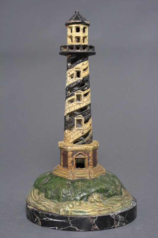 Lighthouse on Onyx Pedestal Doorstop: American - Circa 1925 - 14 1/2" tall This is an amazing doorstop we have not previously seen. Material: Cast Iron and Onyx Base