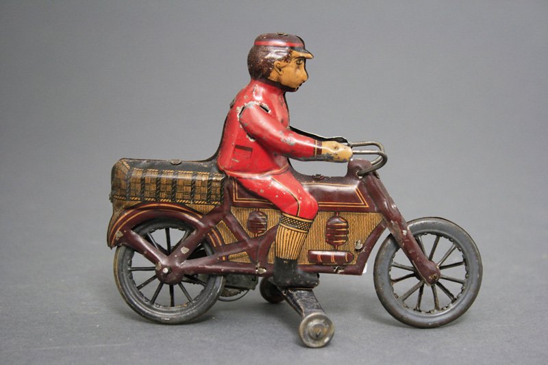 Delivery Motorcycle: Made by Fisher Toys Germany - Circa 1918 A wonderfully lithographed early wind up motorcycle that is 6" long and works well. Material: Tin
