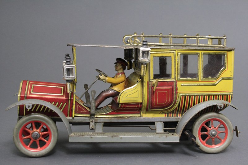 Chauffeur Driven Limousine: Hans Eberl Company Germany - Circa 1915 - 14" long Scarce deluxe version with glass windows. Material: Tin and Glass