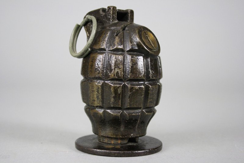 Grenade on Base Still Bank: American - Circa 1920 This is an extremely rare bank. In fact, we have not previously seen one. It is 4” tall and in superior condition. Material: Cast Iron