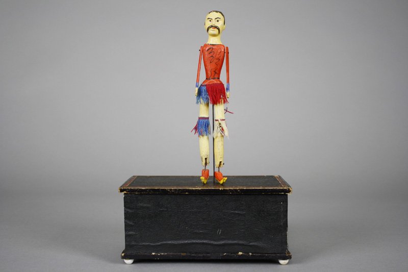 The Dancing Chinaman American Clockwork Toy: Automatic Toy Works New York City - Circa 1875 This is a scarce version with dancing Chinese figure. It works very well and is 10.5” tall. Material: Wood, Fringe and Paper Litho