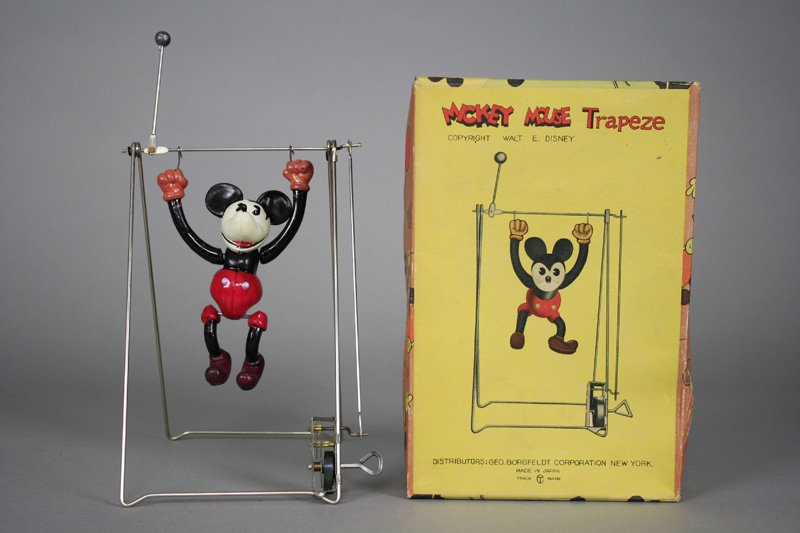 Mickey Mouse Trapeze Artist Celluloid: Japanese - Circa 1938 Distributed by Geo. Borgfeldt & Corp. This colorful celluloid toy is in mint condition and includes the original cardboard box. It is 8.5” tall and works well. Materials: Cellu