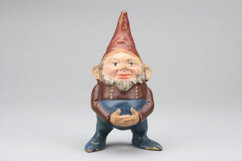 Gnome Holding Belly: Germany - Circa 1900 This little dwarf appears to snack between meals. He is 5.25” tall. Material: Earthenware
