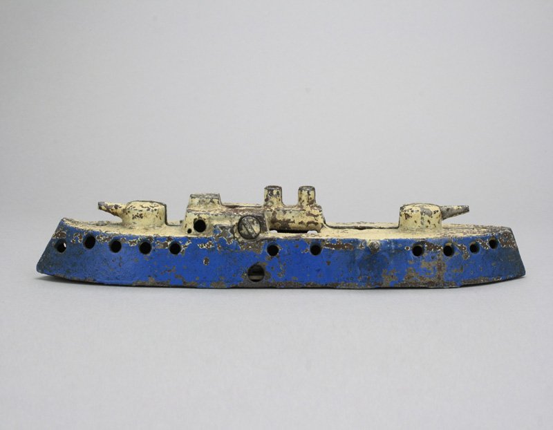Blue Gunboat: Probably Kenton Hardware Kenton, Ohio - Circa 1895 These early gunboat banks are rare. This example without masts. It is 8.5” long. Material: Cast Iron