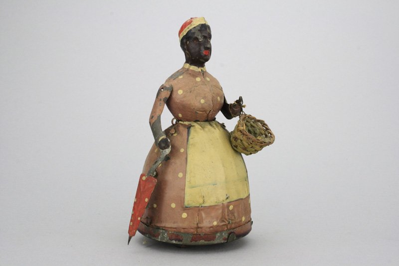 Black Woman Shopping - Gunthermann: Germany - Circa 1915 A classic Gunthermann toy that is 7” tall and works well. Material: Tin and Wicker