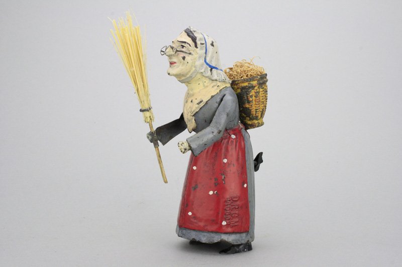 Old Woman with Broom and Basket: Gunthermann - Germany - Circa 1910 This lovely lady stands 6.25” tall and works well. Material: Tin