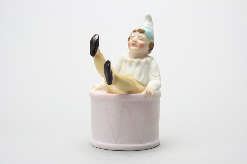 Boy on Drum Still Bank: German - Circa 1905 - 3.75” Tall Similar to the previous lots; this is another colorful and rare German bisque bank. Material: Bisque