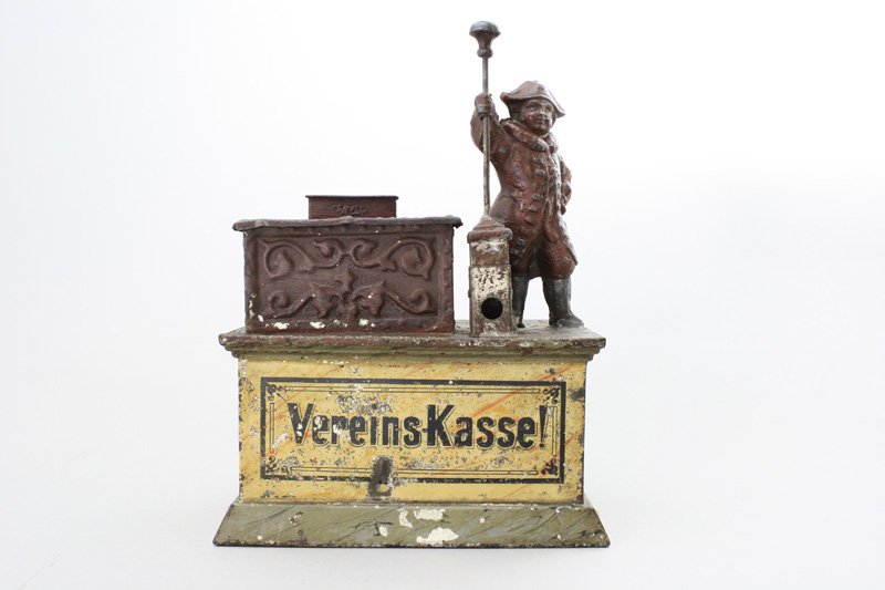 Vereins Kasse Architectural Bank: German - Circa 1910 - 8” Tall The translation of this verbage is “Club Checkout”. This bank must have been used in a smoking club as it has a cigar cutter built into it. Material: Tin