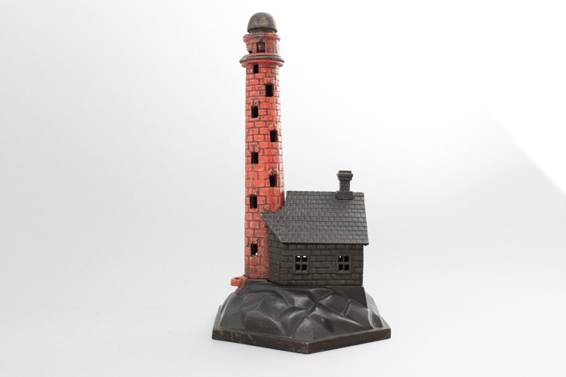 Lighthouse Bank Mechanical Bank: Probably H. L. Judd Mfg. Co. - Connecticut - Circa 1885 The tower can hold 100 nickels. When $5.00 is reached the drawer at the base will open. Material: Cast Iron