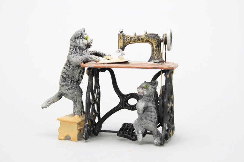 Two Cats at Sewing Machine: Germany - Circa 1915 - 3.125” Long This is a German spelter novelty toy made to resemble the patinated bronzes that were being produced in Art Nouveau Vienna. Material: Spelter