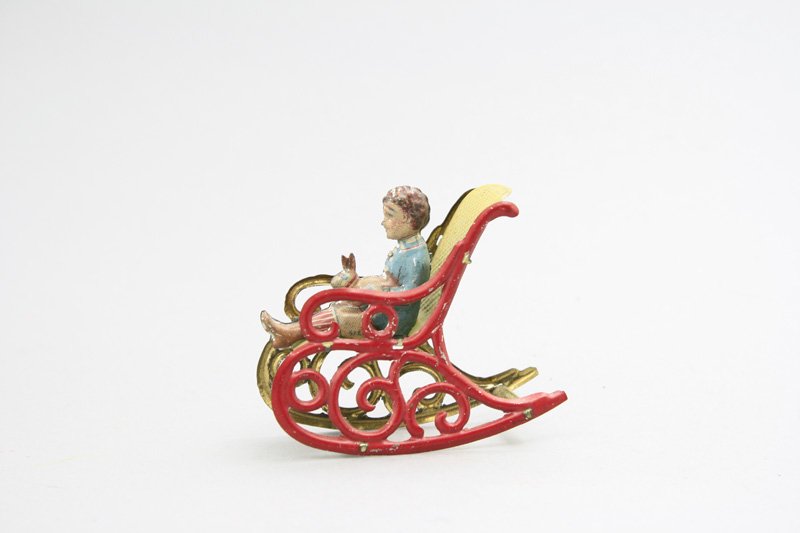 Boy & Rabbit in Rocking Chair: J. Meier Germany - Circa 1925 - 2.75” Long This is a scarce and highly sought after penny toy. It is in Near Mint condition. Material: Tin