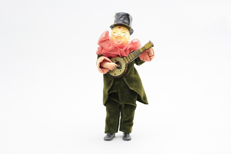 Clown Playing Mandolin Prewar Japanese: Circa 1930 - 12” Tall This is a rare early and graphic celluloid toy. It combines lead, tin, celluloid, cardboard and felt into an impressive, good working toy. Material: Many Materials