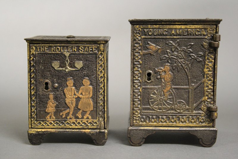 Two Safe Banks: Kyser & Rex - Circa 1880s Included: The Roller Safe (3.625” H) and Young America (4.375” H). Material: Cast Iron