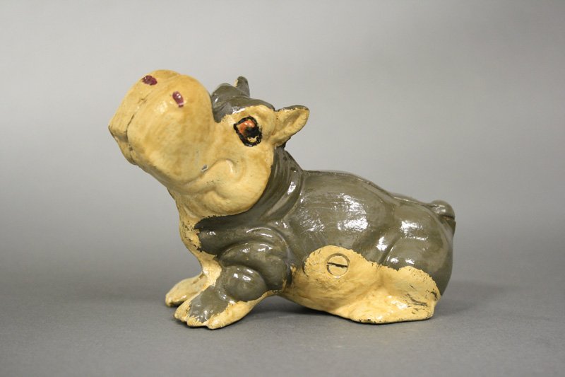 Hippo Seated: American - Circa 1950 - 4” H A rare and colorful bank that we have never seen before. Probably made by a cottage industry foundry. Material: Cast Iron