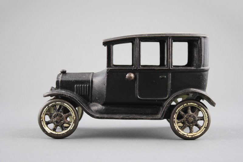 Center Door Sedan: Arcade Mfg. Co. - Circa 1925 - 6.5” L Material: Cast Iron