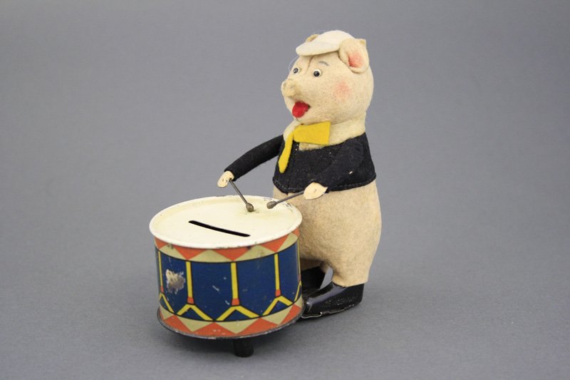 Pig Playing Drum Bank: Schuco Mfg. Germany - Circa 1935 A scarce windup bank that works well. Material: Tin and Fabric