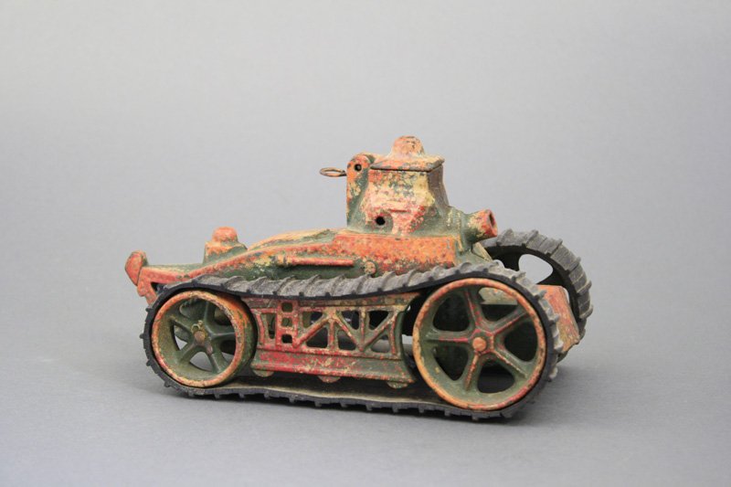 Camouflage Tank: Arcade Mfg. Co. Freeport, Illinois - Circa 1930 - 8.25” L A superior example of the toy. It retains its artillery BB’s. Material: Cast Iron with Rubber Treads
