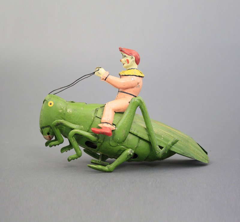 Grasshopper with Clown: Gunthermann German - Circa 1900 - 7.75” L This is a very scarce hand painted toy by Gunthermann. Material: Tin