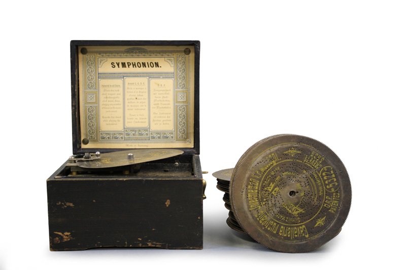 Symphonion “Simplex” Music Player: German - Circa 1910 - 7.5” W x 6.75” D The player works very well. About 20 musical discs. Material: Wood