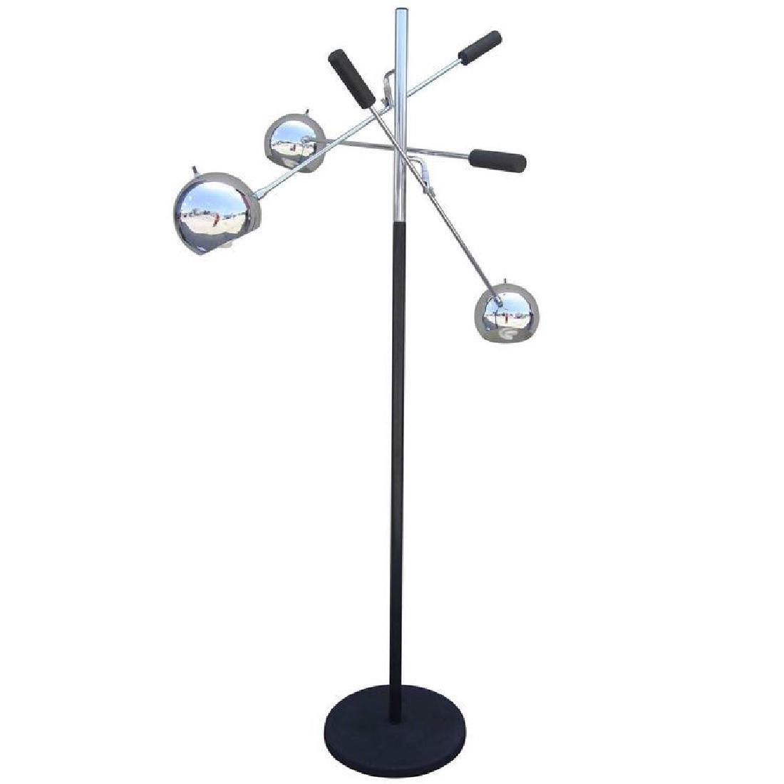 Space Age “Orbiter” Floor Lamp by Robert Sonneman: A rare “Orbiter” floor lamp by Robert Sonneman featuring three shades that can be rotated and fixed to any position. Each shade is balanced by a weighted handle. Supported by a circular iron base.