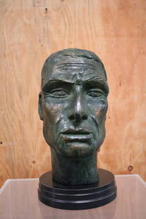 Julius Caesar Head Sculpture: Julius Caesar head sculpture rendered in bronze with a verdigris finish. It sits on a round black wood base. Period: 1960s Condition: Excellent Measurements: Height: 15" Diameter: 8.38" 