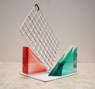 Unusual 80s Lucite Block and Metal Grid Sculpture: 1980s Memphis style sculpture is composed of three pieces. A white metal grid and attached base, and two triangular Lucite pieces that we have arranged on either side. Lucite pieces are not