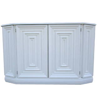 Elegant Console Cabinet in White Lacquer Finish: This console cabinet features two doors which hide a single shelf. The piece, made of white lacquered wood, has intricate ribbing on the front . Original Retail Price $2400 Period 