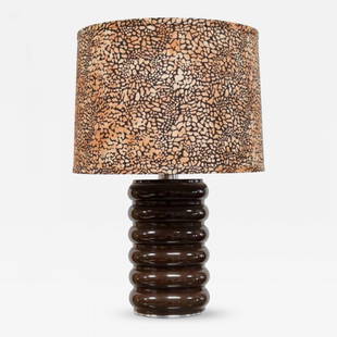 Brown Lacquer Metal Curvilinear Lamp: Brown lacquered metal lamp with curvilinear surface. The base itself is 13.50 diameter. Height: 23" Width: 15" Depth: 15"