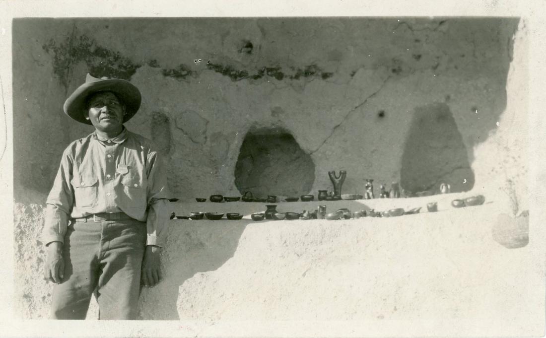 Native American selling pottery, New Mexico. c1920: Native American selling pottery, New Mexico. C1920. 3 x 5in. Some creasing.