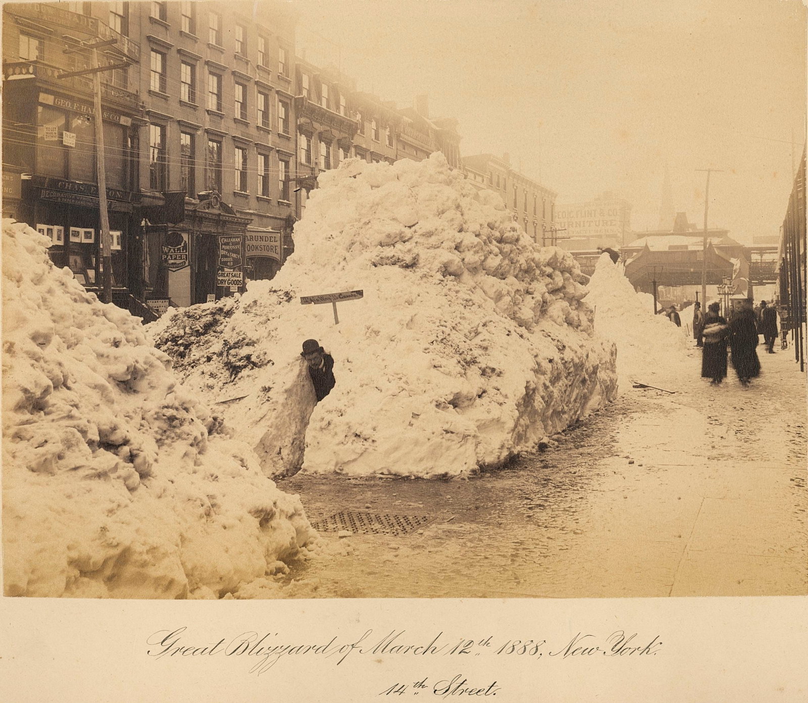 U.S.A. Great Blizzard of March 1888.: Great Blizzard of March 1888, 14th Street, New York. A man has made an ice cave from the pile of snow, his sign over the entrance reads â€“ "This way to Canada!" Good contrast and tonality. Photo