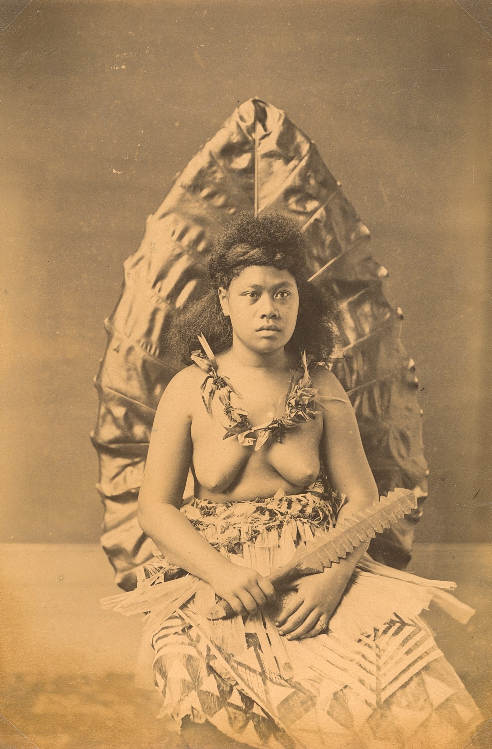 SAMOA. Samoan Woman holding a War Club, c1893: Samoan Woman holding a War Club, c1893. Good contrast and tonality, bottom edge fading. Photographer: Attributed to John Davis. 8.125 x 5.375 in. 20.64 x 13.65 cm