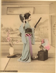 Geisha looking at her mirror. C1880