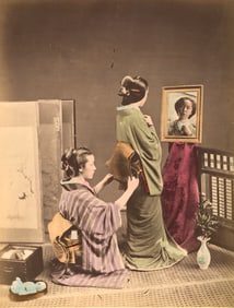 Geisha being dressed by her maid. c1890